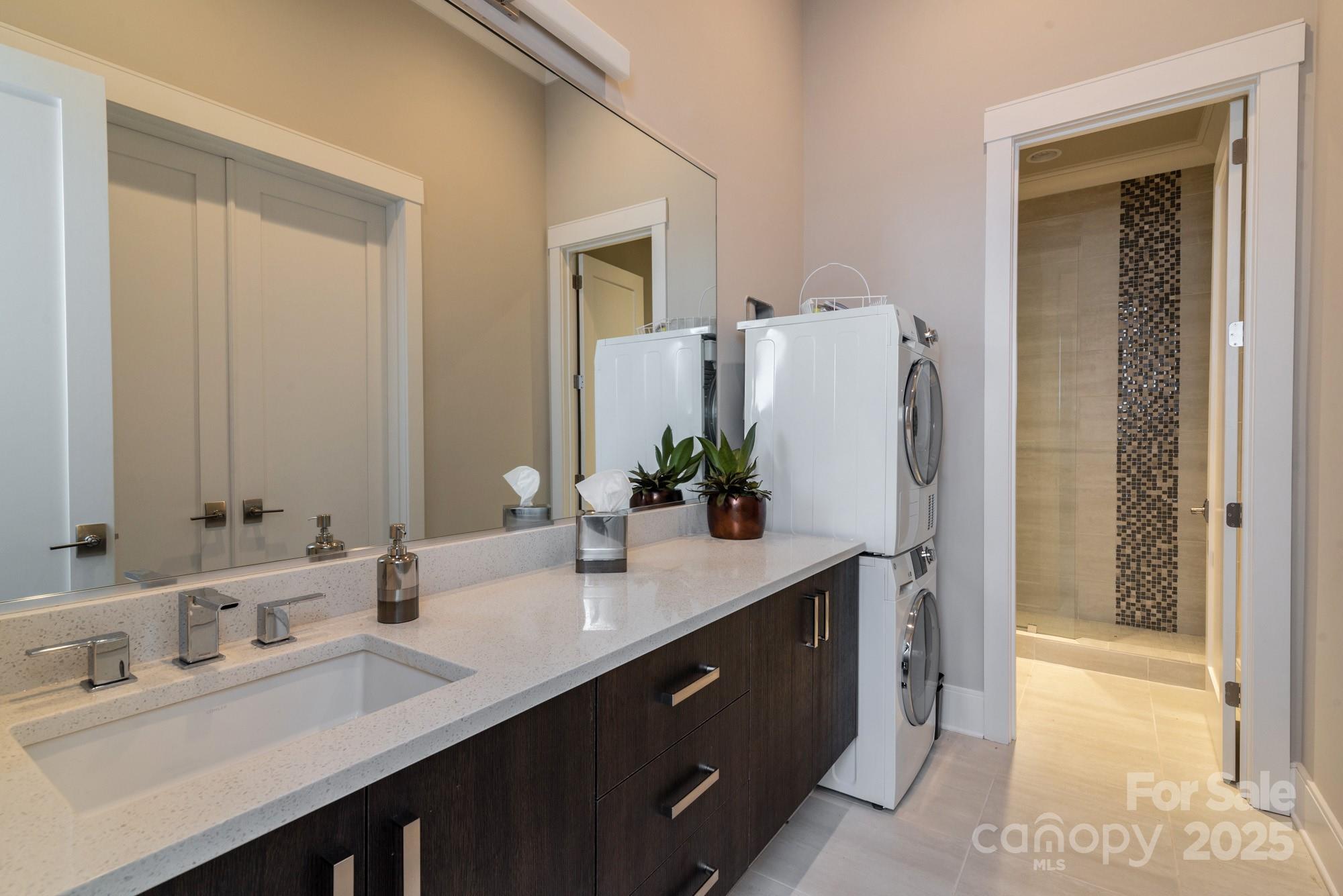4067 Rivendell Road Denver, NC 28037 - Photo 28 of 37 a bathroom with a double vanity sink a and a mirror