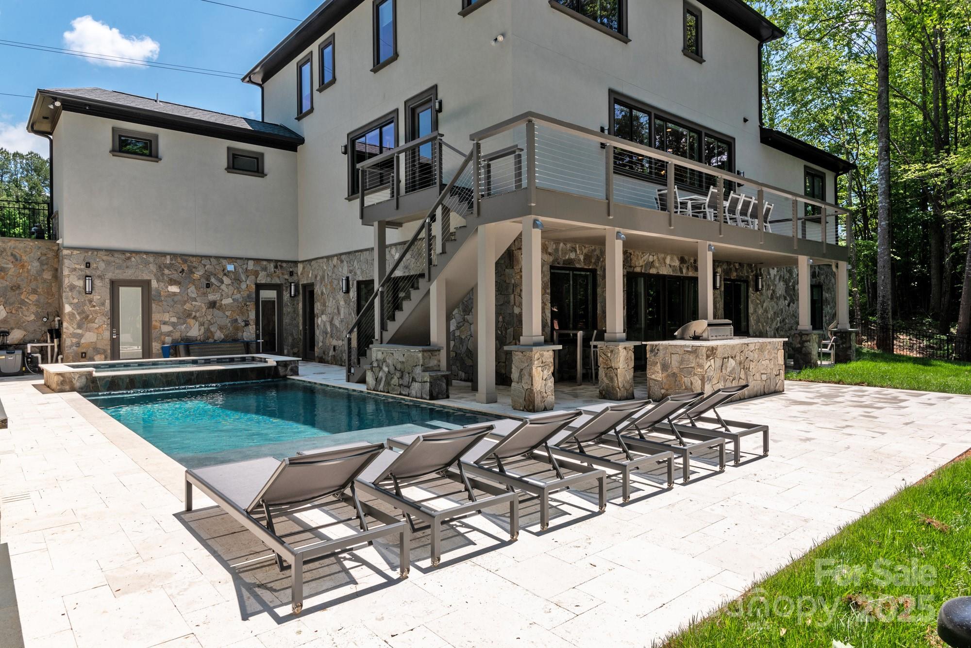 4067 Rivendell Road Denver, NC 28037 - Photo 32 of 37 a front view of a house with swimming pool and sitting area