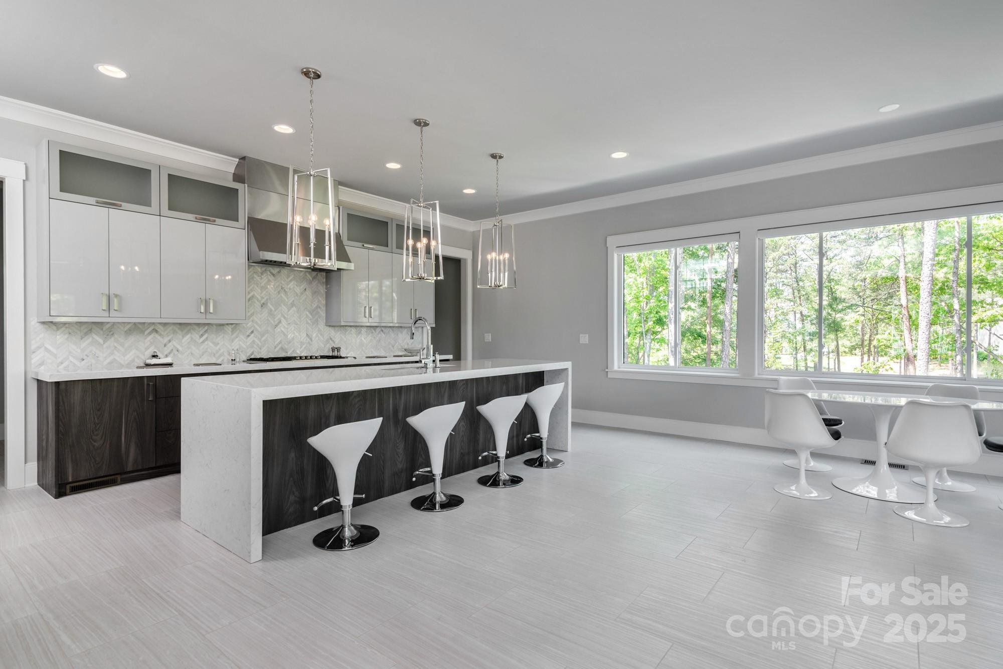 4067 Rivendell Road Denver, NC 28037 - Photo 6 of 37 a large kitchen with kitchen island a large counter top space a sink and appliances