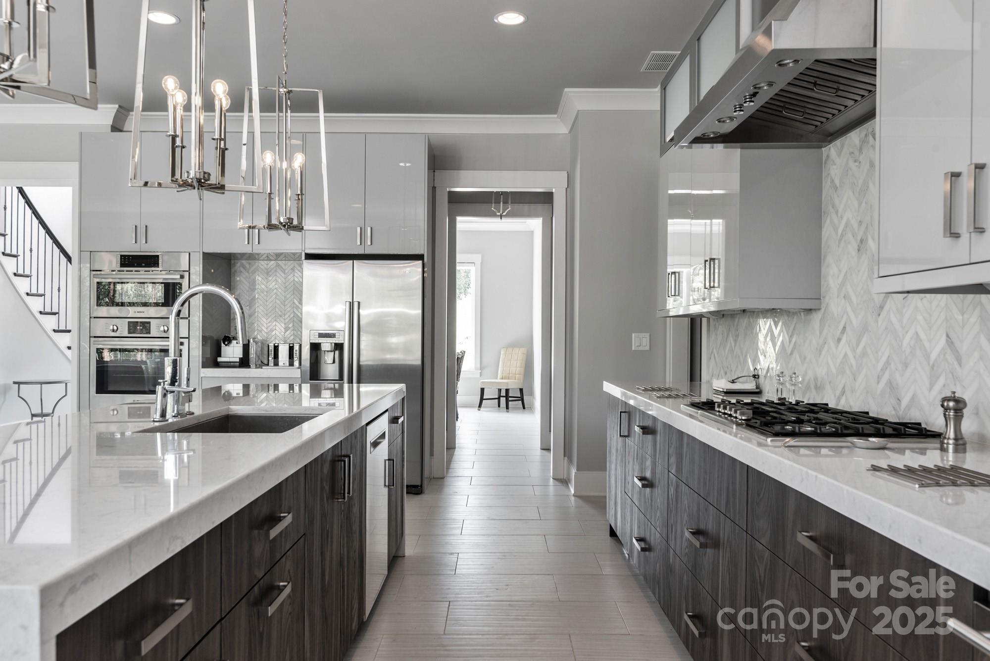 4067 Rivendell Road Denver, NC 28037 - Photo 8 of 37 a kitchen with stainless steel appliances granite countertop a sink a stove and a refrigerator