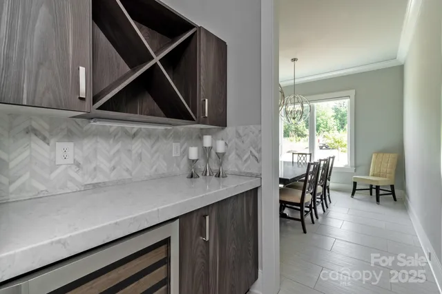 a kitchen with a sink a table and chairs in it