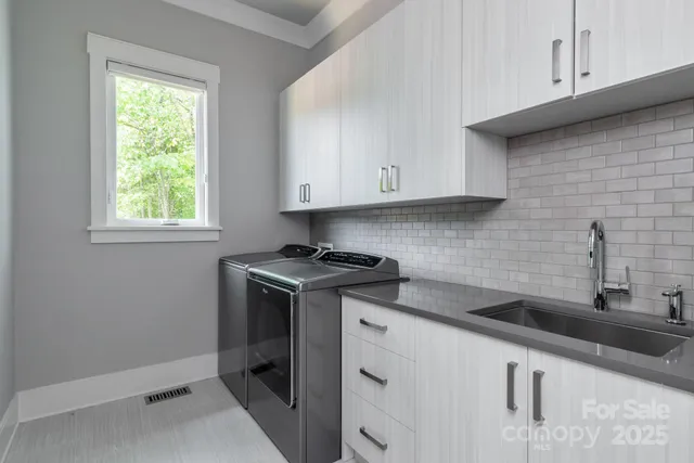 a kitchen with stainless steel appliances granite countertop a sink and a microwave