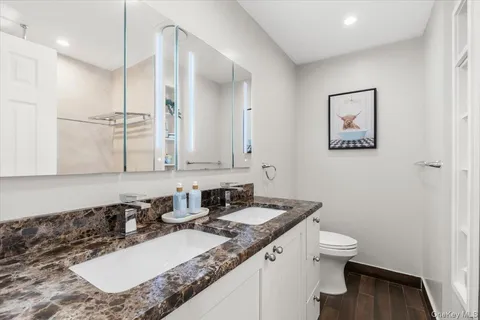 a bathroom with a double vanity sink and mirror