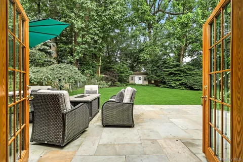 a view of a house with backyard sitting area and garden