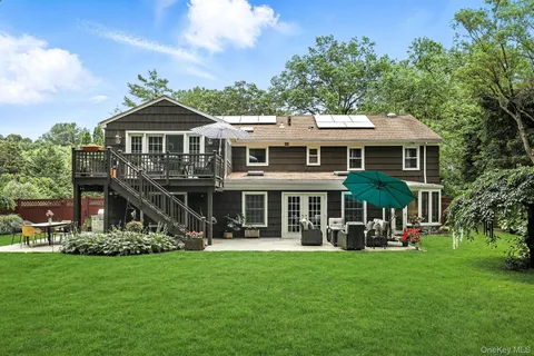 a front view of a house with a garden and sitting area