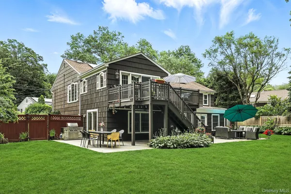 a front view of a house with a garden and sitting area