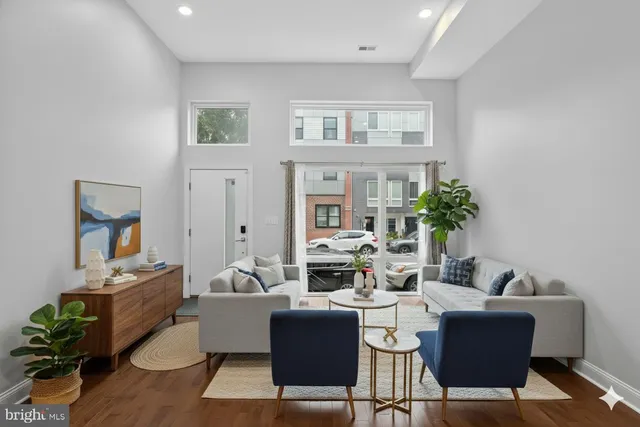 a living room with furniture potted plant and a window