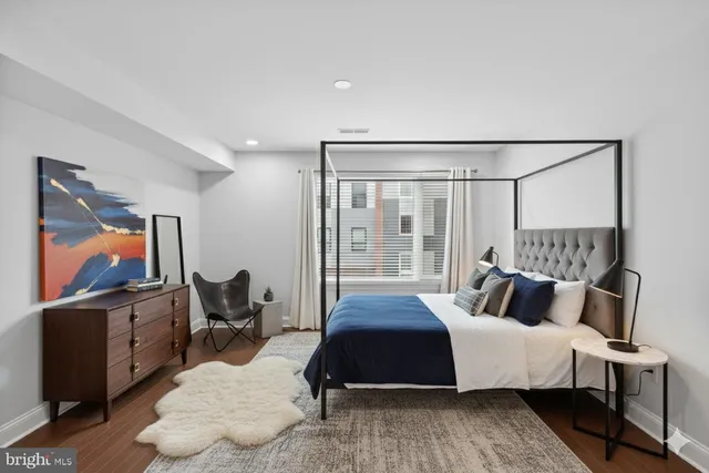 a bedroom with a bed and flat screen tv