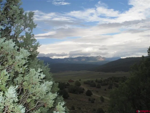 a view of a yard with mountains in the background