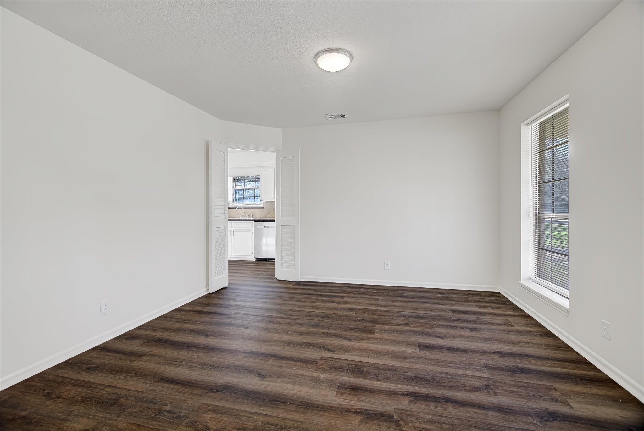 216 Any Way Street Lake Jackson, TX 77566 - Photo 15 of 49 a view of an empty room with wooden floor and a window