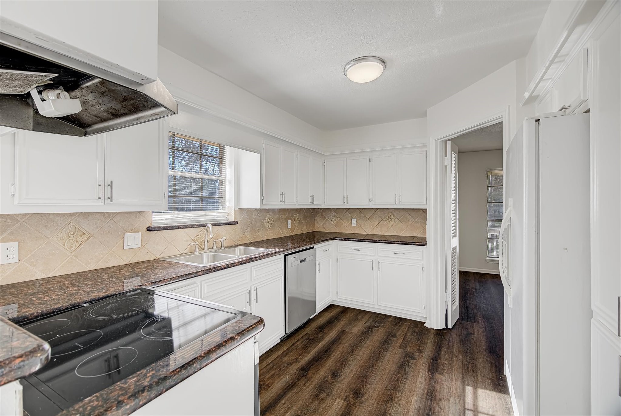 216 Any Way Street Lake Jackson, TX 77566 - Photo 16 of 49 a kitchen with a sink and wooden floor