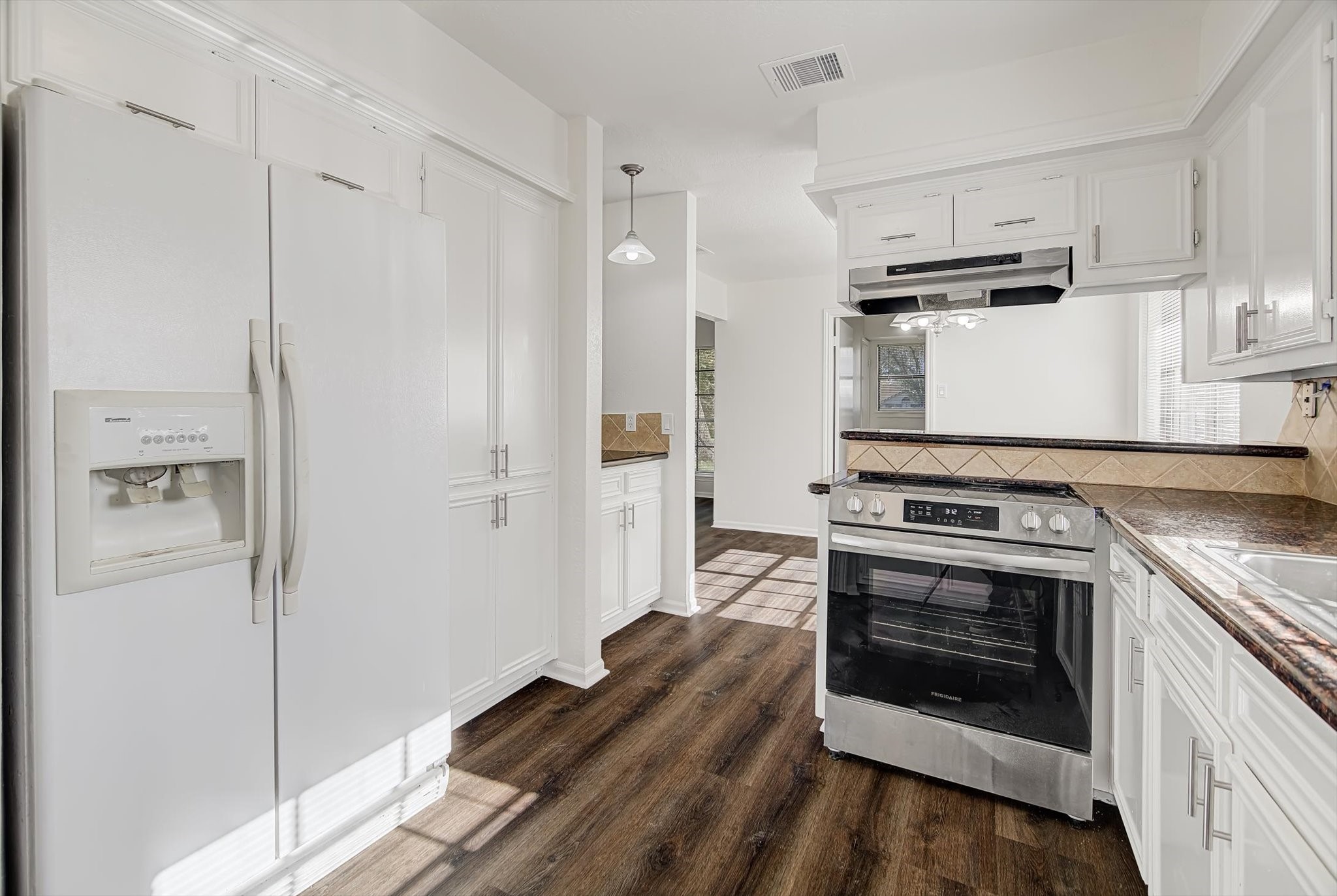 216 Any Way Street Lake Jackson, TX 77566 - Photo 19 of 49 a kitchen with a stove and a refrigerator