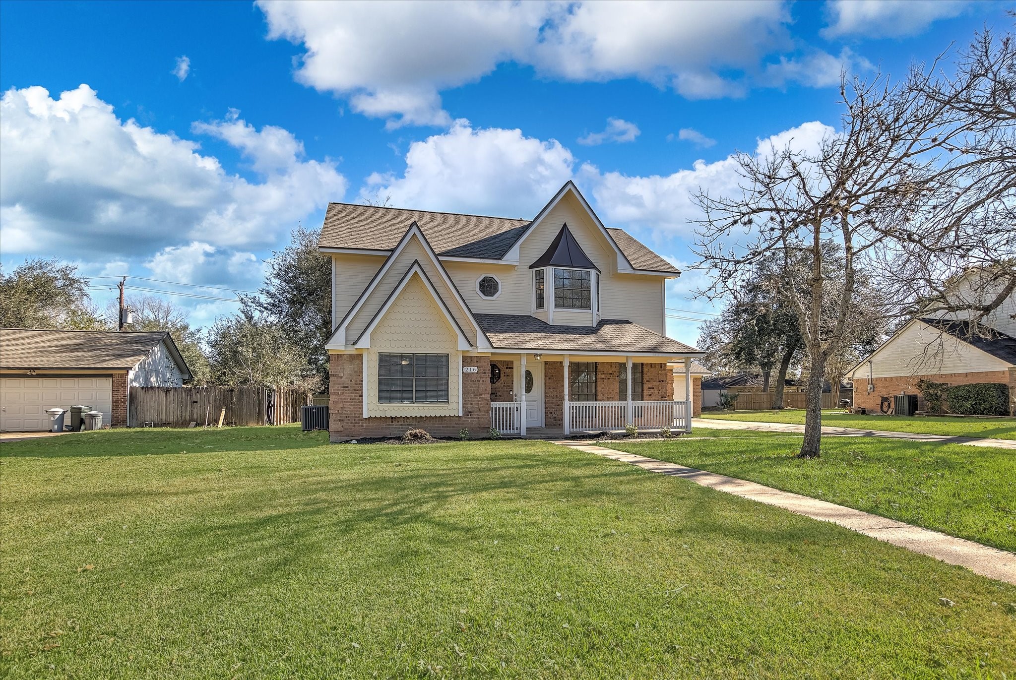 216 Any Way Street Lake Jackson, TX 77566 - Photo 4 of 49 a front view of a house with a garden and trees