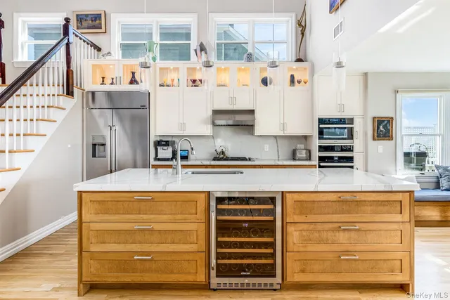a view of kitchen with stainless steel appliances granite countertop cabinets and window