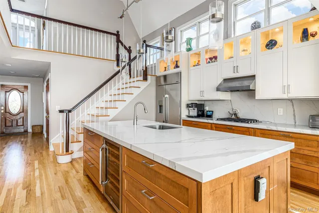 a view of entryway and kitchen with wooden floor