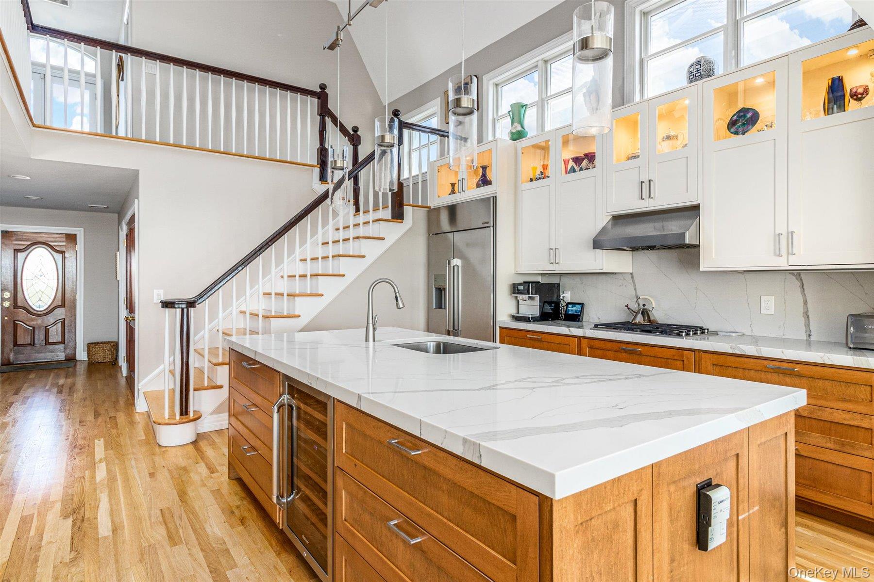 803 Dune Road West Hampton Dunes, NY 11978 - Photo 4 of 8 a view of entryway and kitchen with wooden floor