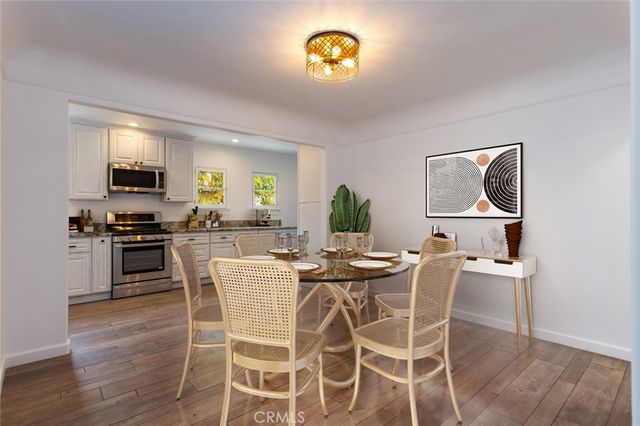 a view of a dining room with furniture and wooden floor