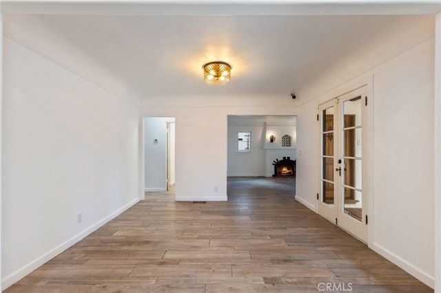 a view of a livingroom with wooden floor and cabinet