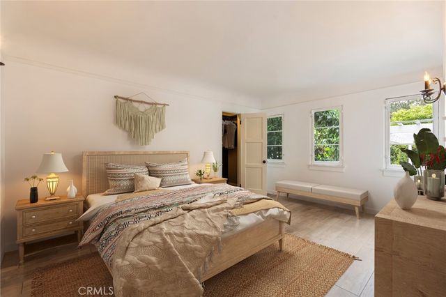 a bedroom with a bed and wooden floor