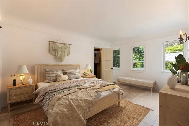a bedroom with a bed and wooden floor