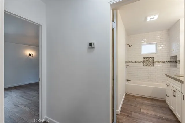 a bathroom with a granite countertop sink a toilet and shower