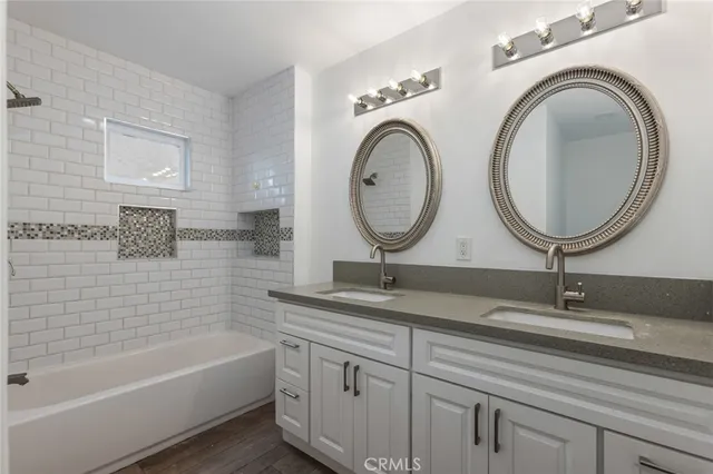 a bathroom with a granite countertop sink mirror and vanity