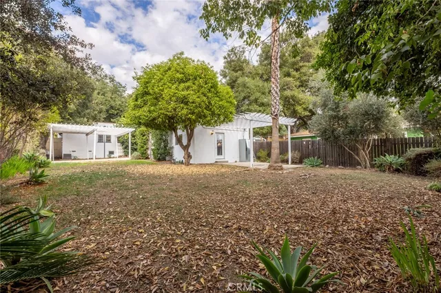 a front view of house with yard and trees