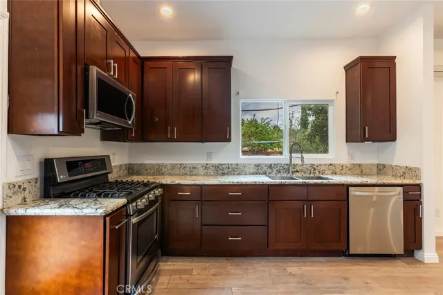 a kitchen with a sink stove and microwave