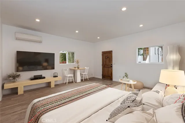 a bedroom with a bed and a flat screen tv