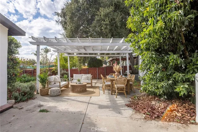 a view of a patio with a table and chairs under an umbrella