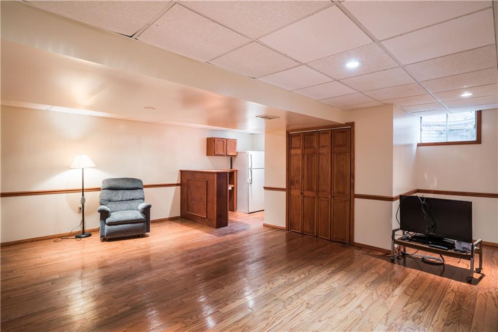 1964 Redcoach Road Allison Park, PA 15101 - Photo 20 of 25 Lower level game room with hardwood flooring, bar area and high ceilings.