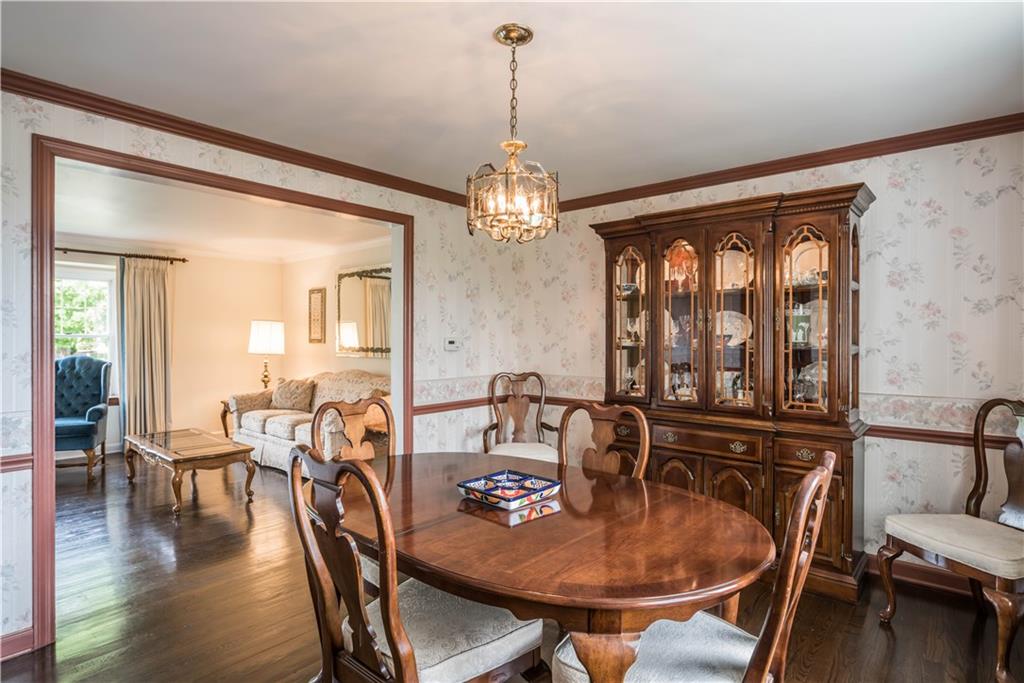 1964 Redcoach Road Allison Park, PA 15101 - Photo 7 of 25 The dining room also has hardwood flooring, chair and crown molding and overlooks the level yard.