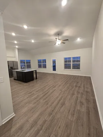 a kitchen with a sink a stove a refrigerator and cabinets