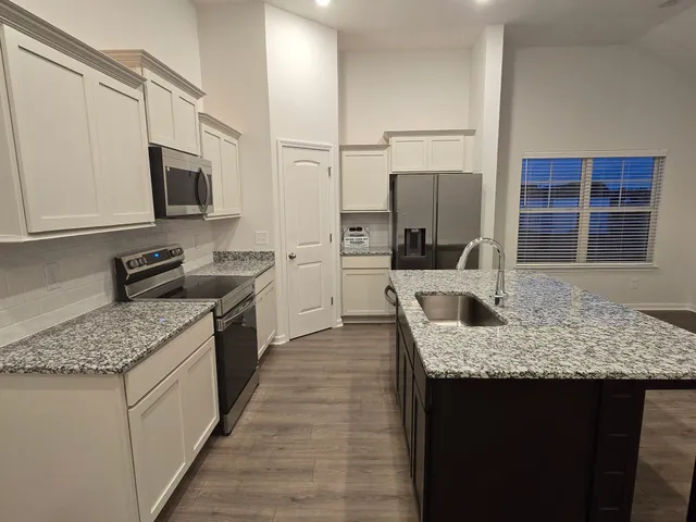a view of storage and utility room with a refrigerator