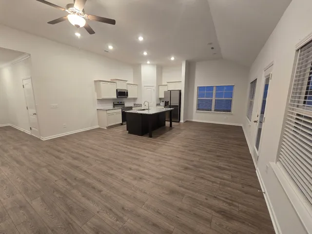 a view of kitchen with a sink and refrigerator