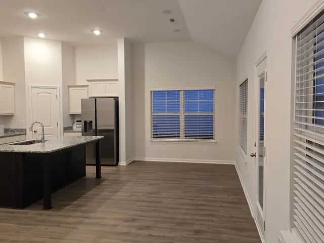 a view of kitchen with furniture and wooden floor