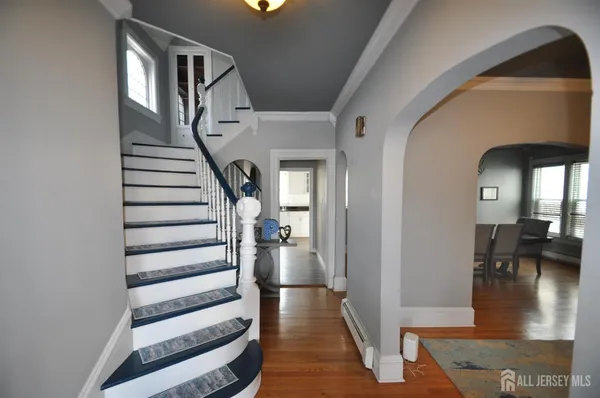 a view of entryway and hall with wooden floor