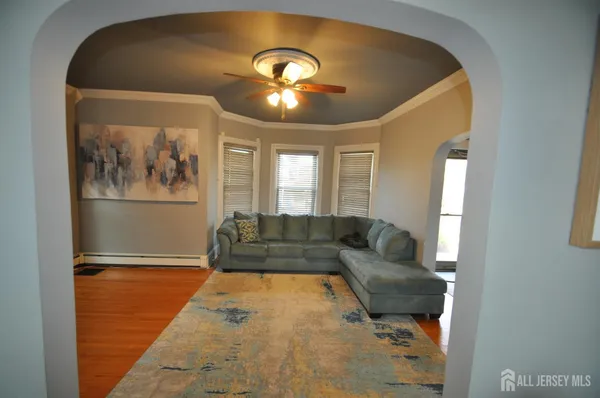 a living room with furniture and a chandelier