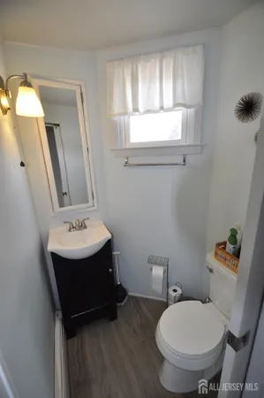 a bathroom with a sink toilet and mirror