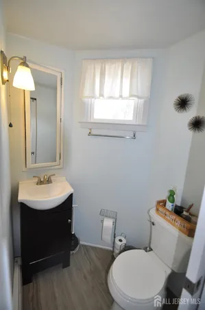 a bathroom with a sink toilet and mirror