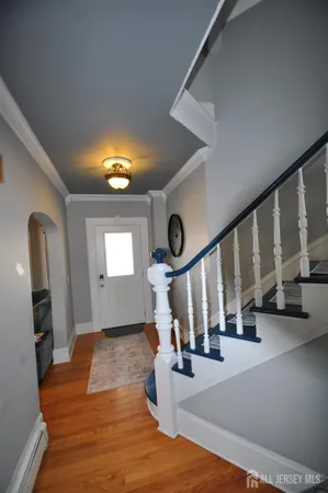 a view of an entryway with wooden floor