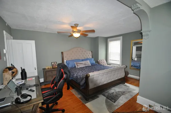 a bedroom with a bed and a chandelier