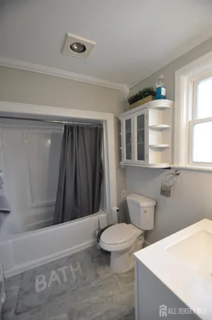 a bathroom with a toilet a sink and bathtub