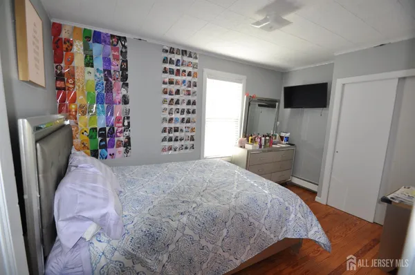 a bedroom with a bed and a television