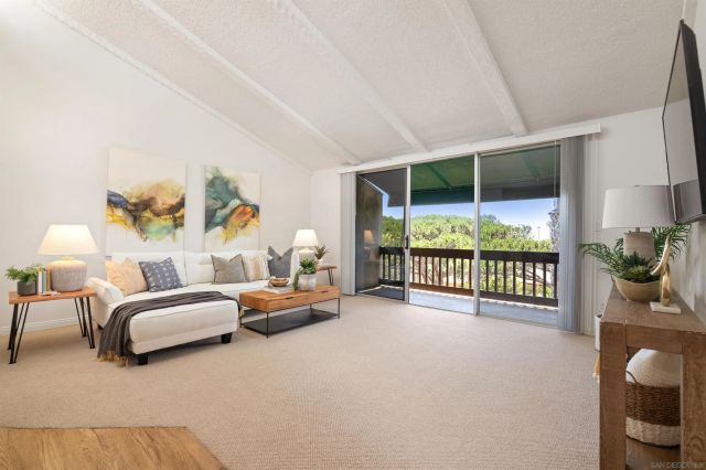 a bedroom with furniture and large window