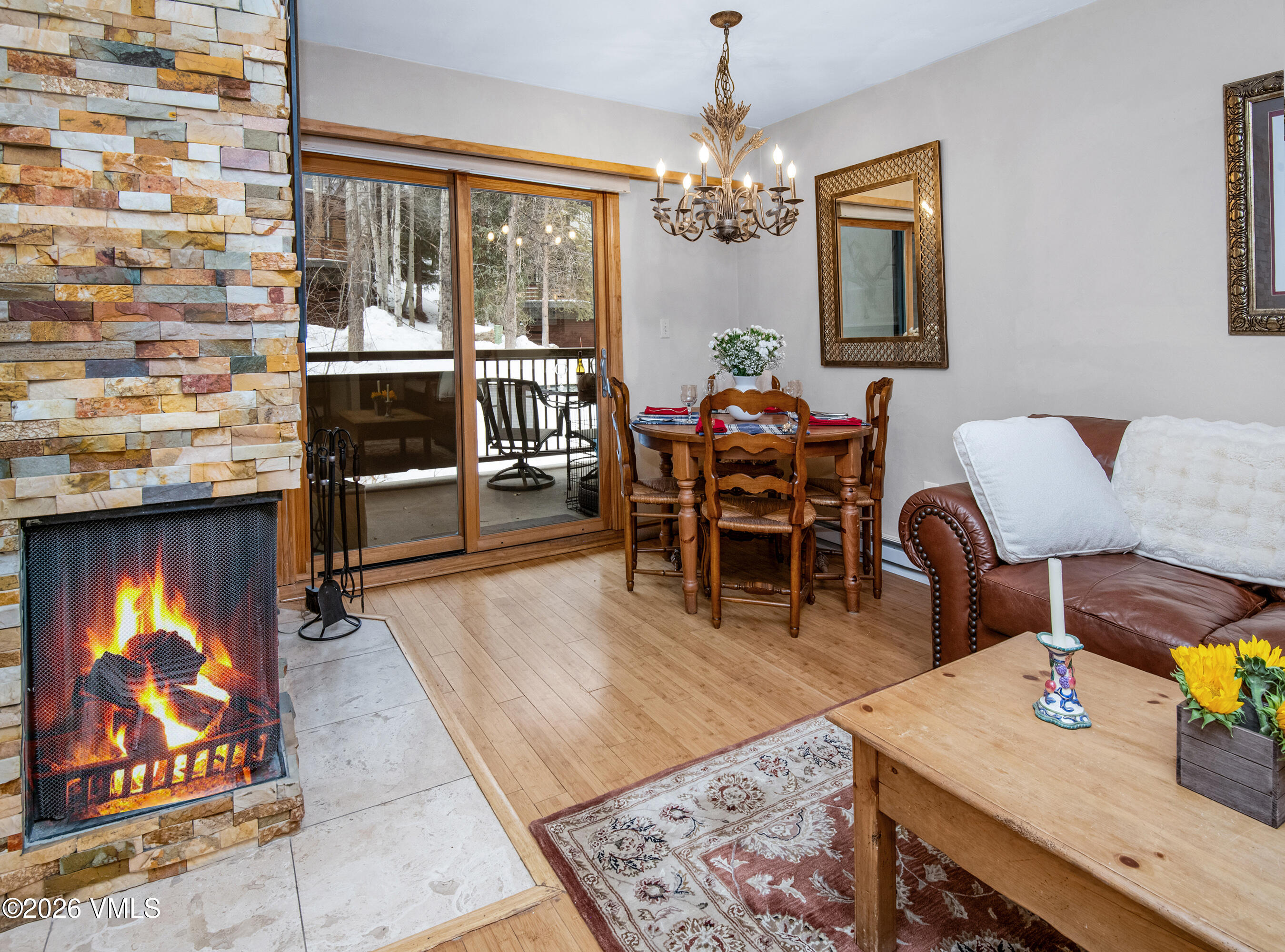 1650 Fall Ridge Road, Unit 202 Vail, CO 81657 - Photo 8 of 32 a view of a dining room with furniture and chandelier