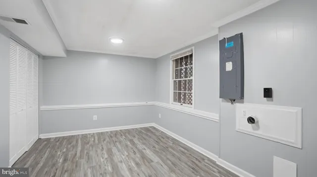 wooden floor in an empty room with a window