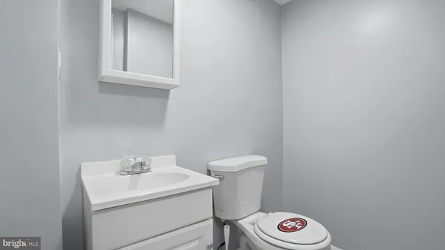 a bathroom with a sink a toilet and a window