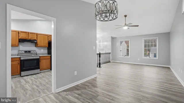 a view of kitchen with sink and refrigerator