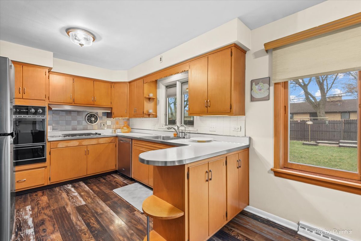 431 North Melrose Avenue Elgin, IL 60123 - Photo 14 of 32 a kitchen with stainless steel appliances granite countertop a sink and cabinets